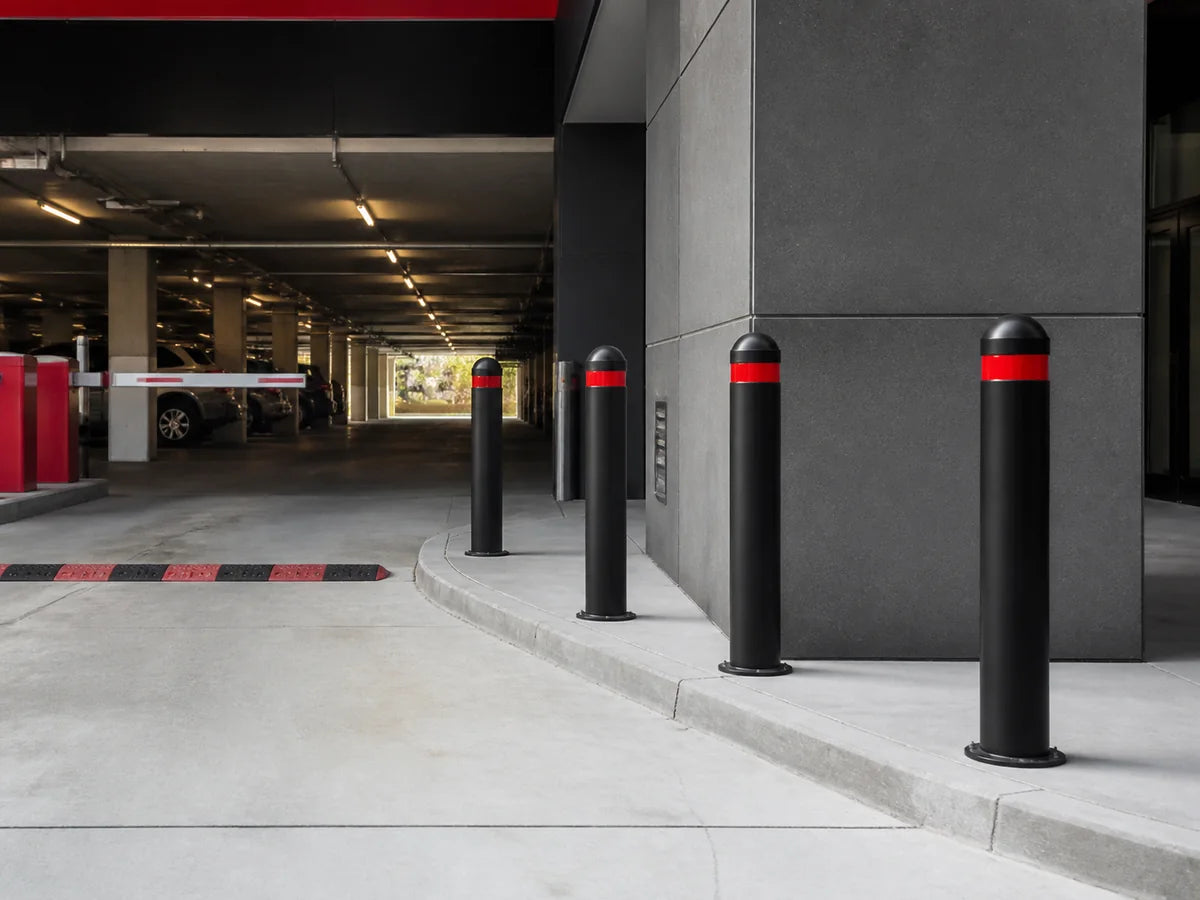 Safety bollards protecting a commercial parking facility entrance